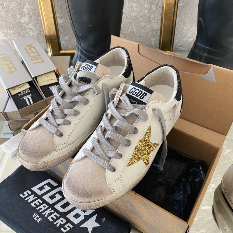 golden goose S*per-star sneakers with golden glitter and black heel tab