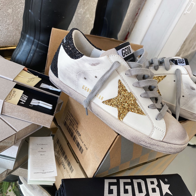 golden goose S*per-star sneakers with golden glitter and black heel tab