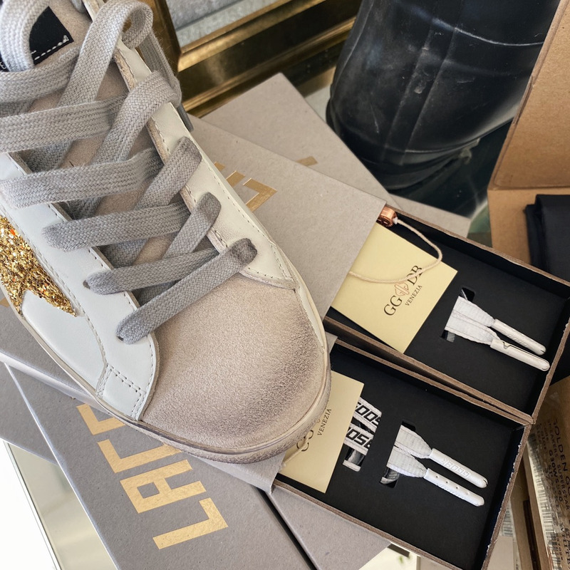 golden goose S*per-star sneakers with golden glitter and black heel tab