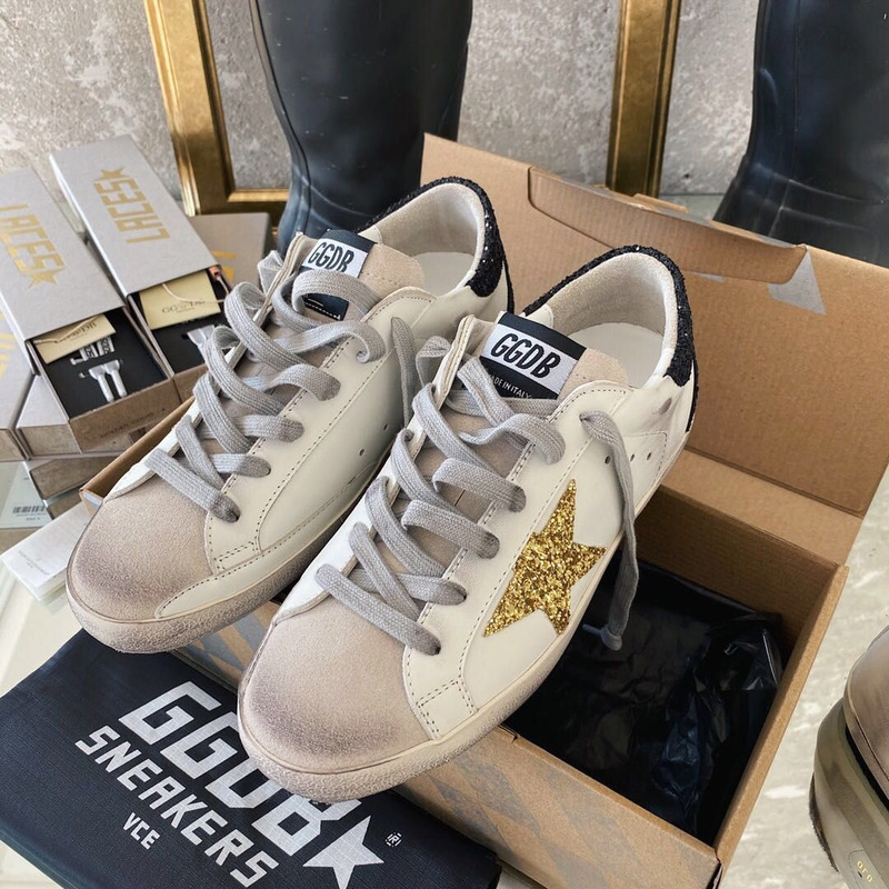 golden goose men’s S*per-star sneakers with golden glitter and black heel tab